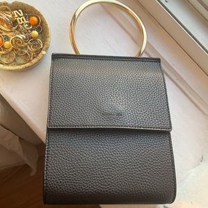 Black leather Angela Roi purse with gold handle